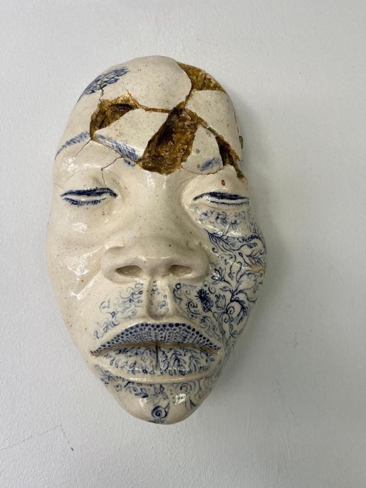 Mind Blowing by Evan Oberholster — white ceramic mask with gold-glazed patches