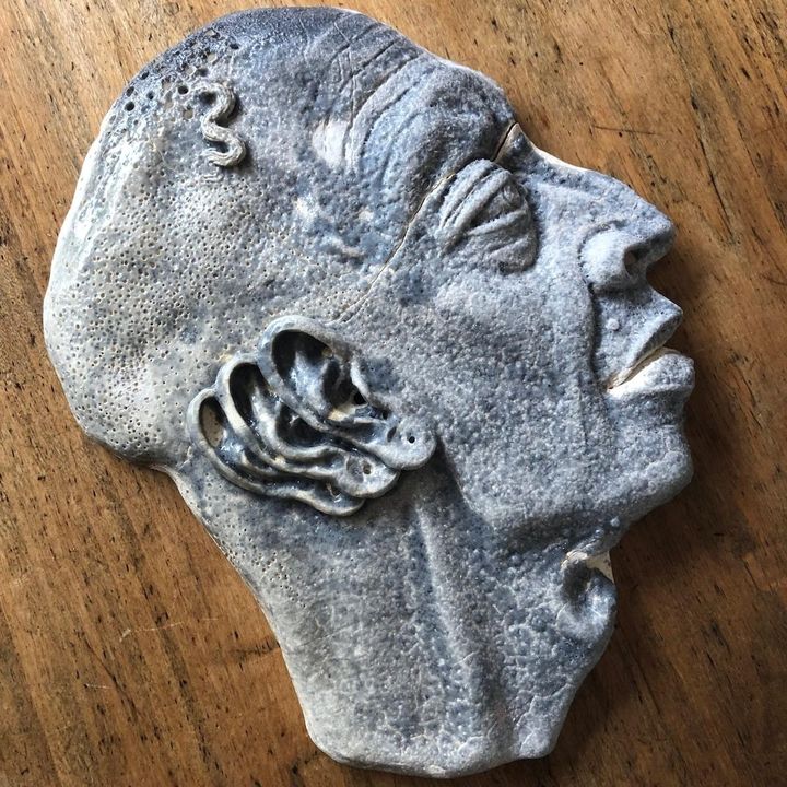 I Hear You by Evan Oberholster — blue-grey ceramic mask of a face in profile with a sculpted ear