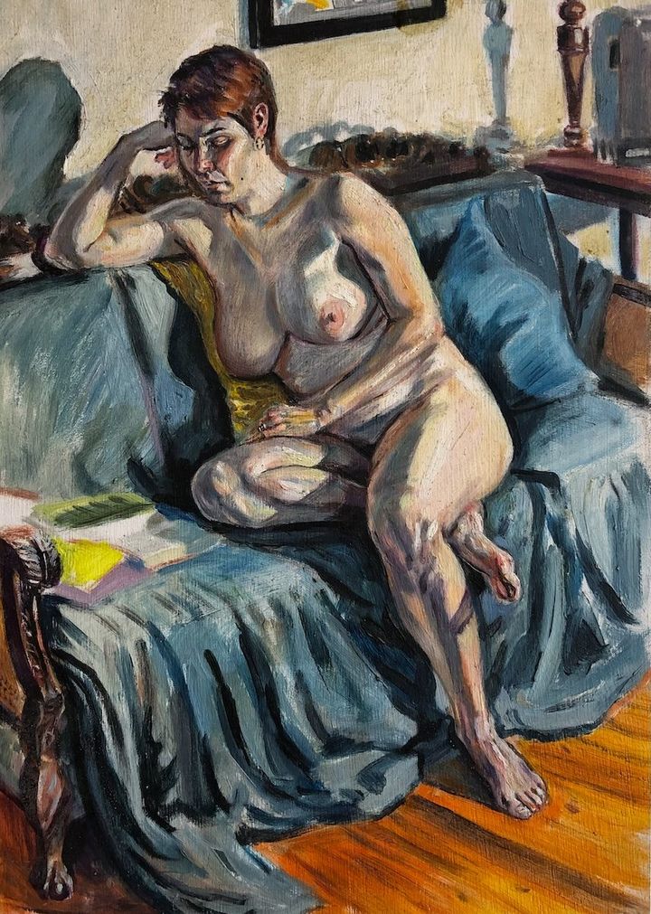 Woman on Couch by Evan Oberholster — oil painting of a seated nude woman with short red hair on a blue-grey couch